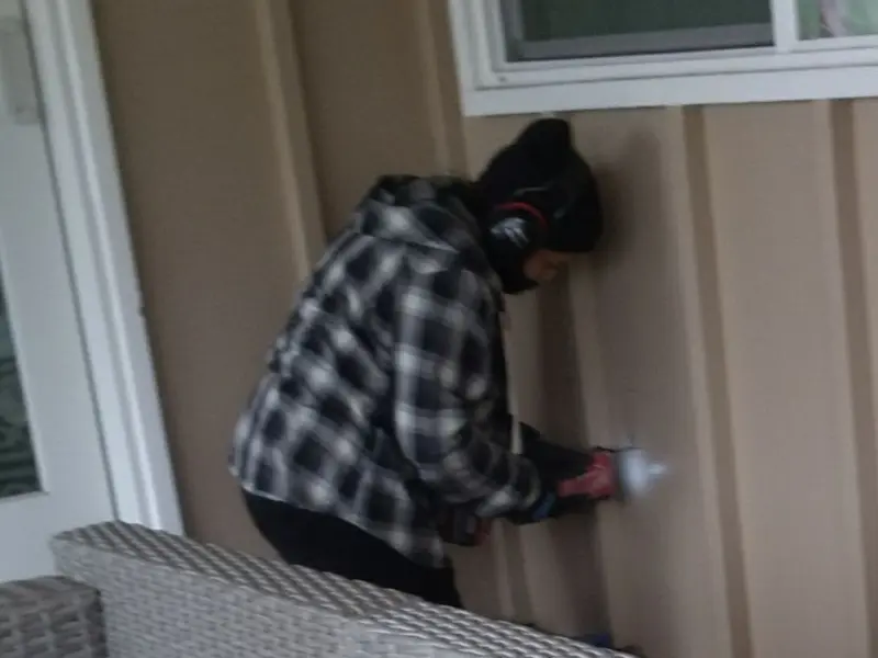 Professional electrician installing an exterior outlet in Grant