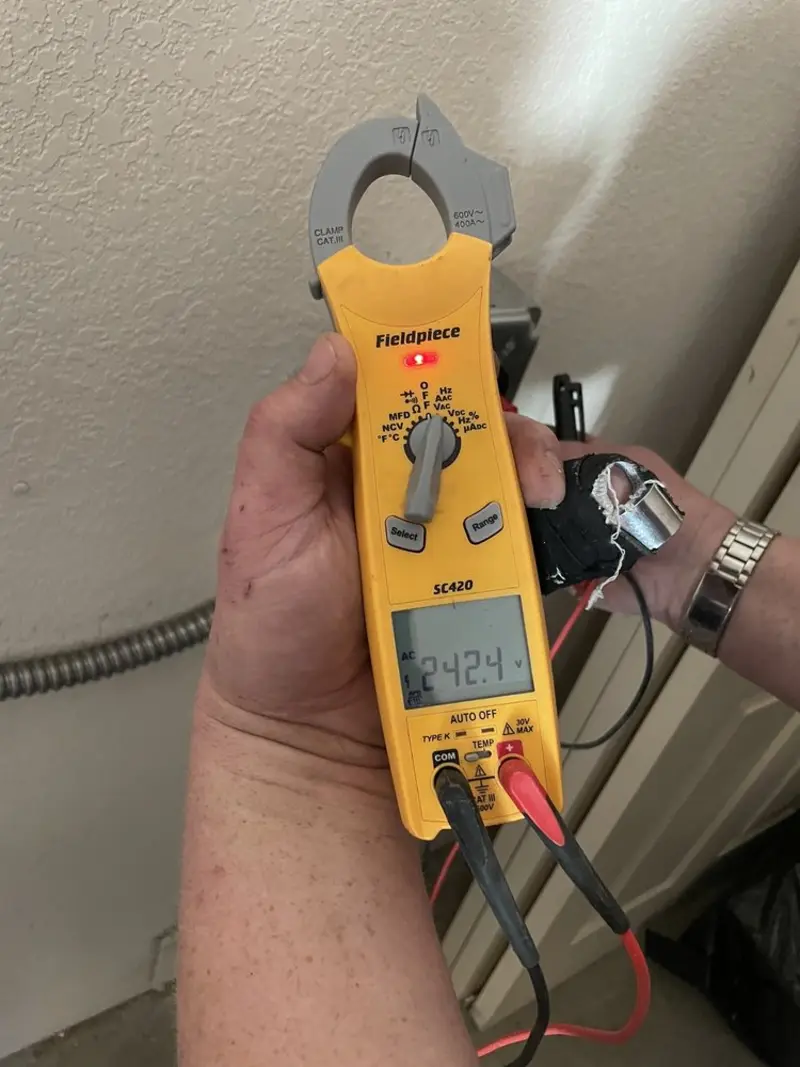 Voltage testing with clamp meter during Ceiling Fan Installation in Grant